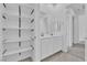 Bright bathroom with double vanity, storage shelves, and modern fixtures at 11049 Concord Valley Drive, Las Vegas, NV 89135