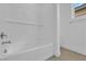Clean white bathroom features a tiled tub-shower combo with a built-in shelf at 11049 Concord Valley Drive, Las Vegas, NV 89135