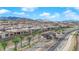 A beautiful community shot showcasing palm trees along entry and new homes with mountain views in the background at 11049 Concord Valley Drive, Las Vegas, NV 89135