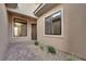 Inviting entryway featuring tile flooring, neutral stucco exterior, and modern landscaping elements at 11049 Concord Valley Drive, Las Vegas, NV 89135