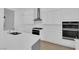 Bright, open kitchen features stainless steel appliances, an island, and ample white cabinets at 11049 Concord Valley Drive, Las Vegas, NV 89135