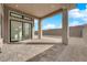 Covered patio with pavers featuring a modern sliding glass door leading to the home's interior at 11049 Concord Valley Drive, Las Vegas, NV 89135