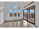 A view of the backyard and patio from the interior featuring tile flooring and large windows and sliding glass door at 11049 Concord Valley Drive, Las Vegas, NV 89135