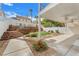 Home's backyard with a patio and layered brick retaining wall at 1109 Maserati Dr, Las Vegas, NV 89117