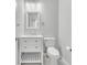 Bathroom with white vanity, toilet, and updated fixtures at 1109 Maserati Dr, Las Vegas, NV 89117