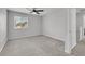 Bright, carpeted bedroom with a window, neutral walls, and a ceiling fan at 1109 Maserati Dr, Las Vegas, NV 89117