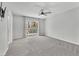 Spacious bedroom features a ceiling fan and sliding glass door to a balcony at 1109 Maserati Dr, Las Vegas, NV 89117