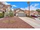 Charming two-story home featuring a well-maintained front yard, a driveway, and a two-car garage at 1109 Maserati Dr, Las Vegas, NV 89117