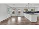 Bright kitchen boasts hardwood floors, granite countertops, island, and modern pendant lighting at 1109 Maserati Dr, Las Vegas, NV 89117