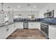 Modern kitchen with stainless appliances, granite countertops, hardwood floors, and stylish cabinets at 1109 Maserati Dr, Las Vegas, NV 89117