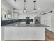 Modern kitchen features granite countertops, stainless steel appliances, island, and pendant lighting at 1109 Maserati Dr, Las Vegas, NV 89117