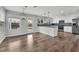 Open-concept kitchen and dining area with granite countertops, stainless appliances, and hardwood floors at 1109 Maserati Dr, Las Vegas, NV 89117