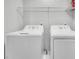 Bright laundry room equipped with a washer, dryer, and storage shelving at 1109 Maserati Dr, Las Vegas, NV 89117
