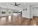 Bright living room featuring hardwood floors, a ceiling fan, modern kitchen, and dining area at 1109 Maserati Dr, Las Vegas, NV 89117