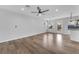 Spacious, bright living room with hardwood floors and an open concept design that leads to the kitchen and dining area at 1109 Maserati Dr, Las Vegas, NV 89117