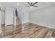 Empty living room with hardwood floors, a ceiling fan, and a staircase at 1109 Maserati Dr, Las Vegas, NV 89117