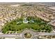 An overhead shot of a neighborhood park and surrounding community with manicured green spaces and recreational amenities at 11228 Hedgemont Ave, Las Vegas, NV 89138