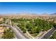 Aerial view of a community park with mature trees and walking trails in a residential neighborhood at 11228 Hedgemont Ave, Las Vegas, NV 89138