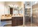 Bathroom featuring dark wood vanity, a large mirror, and a walk-in shower at 11228 Hedgemont Ave, Las Vegas, NV 89138