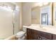 Bathroom featuring a glass-enclosed shower, a single vanity with dark cabinets, and tiled floors at 11228 Hedgemont Ave, Las Vegas, NV 89138
