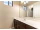 Vanity features dark wood cabinets, a large mirror, and white countertops at 11228 Hedgemont Ave, Las Vegas, NV 89138