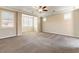 Spacious bedroom with large windows and a tray ceiling with a fan at 11228 Hedgemont Ave, Las Vegas, NV 89138