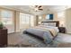 Spacious bedroom with many windows, ceiling fan, and a blue accent rug at 11228 Hedgemont Ave, Las Vegas, NV 89138