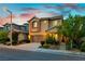 Inviting two-story home with landscaped front yard and attached two-car garage at dusk at 11228 Hedgemont Ave, Las Vegas, NV 89138