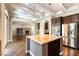 Open concept kitchen with island and stainless appliances features granite countertops and access to the living room at 11228 Hedgemont Ave, Las Vegas, NV 89138