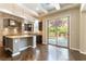 Well-appointed kitchen features granite countertops, island with bar seating, and a view of the pool at 11228 Hedgemont Ave, Las Vegas, NV 89138