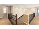 Second floor landing features wood banisters and neutral carpet at 11228 Hedgemont Ave, Las Vegas, NV 89138