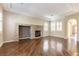 Bright living room boasts a stone fireplace, coffered ceilings, and many windows, providing ample natural light at 11228 Hedgemont Ave, Las Vegas, NV 89138
