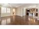 Open-concept living room leading to kitchen and stairs featuring hardwood floors and coffered ceilings at 11228 Hedgemont Ave, Las Vegas, NV 89138