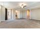 Large carpeted primary bedroom with ceiling fan, tray ceiling, and door to balcony at 11228 Hedgemont Ave, Las Vegas, NV 89138