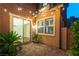 Brick backyard patio with plants, sliding glass door, and a side gate at 11228 Hedgemont Ave, Las Vegas, NV 89138