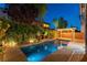 Inviting backyard featuring a private pool, elegant pergola, and lush landscaping perfect for outdoor relaxation at 11228 Hedgemont Ave, Las Vegas, NV 89138