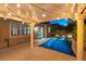Beautiful pool and backyard with patio and string lights at dusk at 11228 Hedgemont Ave, Las Vegas, NV 89138
