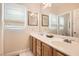 Well-lit bathroom featuring double sinks, and a large mirror at 11278 Tenza Ct, Las Vegas, NV 89141