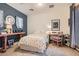 Cozy bedroom with stylish decor, featuring a floral bedspread, desk, and complementary wall accents at 11278 Tenza Ct, Las Vegas, NV 89141