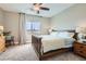 Comfortable bedroom featuring a ceiling fan, carpeted floor, and a window offering scenic views at 11278 Tenza Ct, Las Vegas, NV 89141
