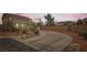 Long concrete driveway leading up to the house surrounded by desert landscaping at 11278 Tenza Ct, Las Vegas, NV 89141