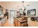 Open kitchen with wood cabinets, granite countertops, and stainless steel appliances at 11278 Tenza Ct, Las Vegas, NV 89141