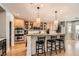 Bright kitchen with counter seating, wood cabinets, and modern stainless steel appliances at 11278 Tenza Ct, Las Vegas, NV 89141