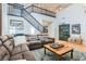 Spacious living room with hardwood floors, staircase, and plenty of natural light at 11278 Tenza Ct, Las Vegas, NV 89141