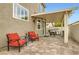 Outdoor patio area featuring red lounge chairs, grill and dining space with a covered pergola at 11278 Tenza Ct, Las Vegas, NV 89141