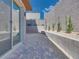 Low-maintenance backyard with gravel landscaping, modern block wall, and brick pavers at 11946 Glide Reflection Ave, Las Vegas, NV 89138