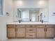 Bright bathroom featuring a double vanity with sleek countertops and modern fixtures at 11946 Glide Reflection Ave, Las Vegas, NV 89138