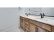 Bright bathroom featuring a double vanity with sleek countertops and modern fixtures at 11946 Glide Reflection Ave, Las Vegas, NV 89138