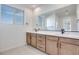 Bathroom featuring a double vanity with sleek countertops and modern fixtures at 11946 Glide Reflection Ave, Las Vegas, NV 89138