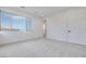 Bright, carpeted bedroom with a large window at 11946 Glide Reflection Ave, Las Vegas, NV 89138